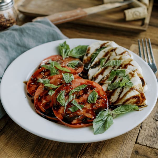 Frittella Italian Cafe's Caprese salad with sliced tomatoes, mozzarella, basil, and balsamic glaze.